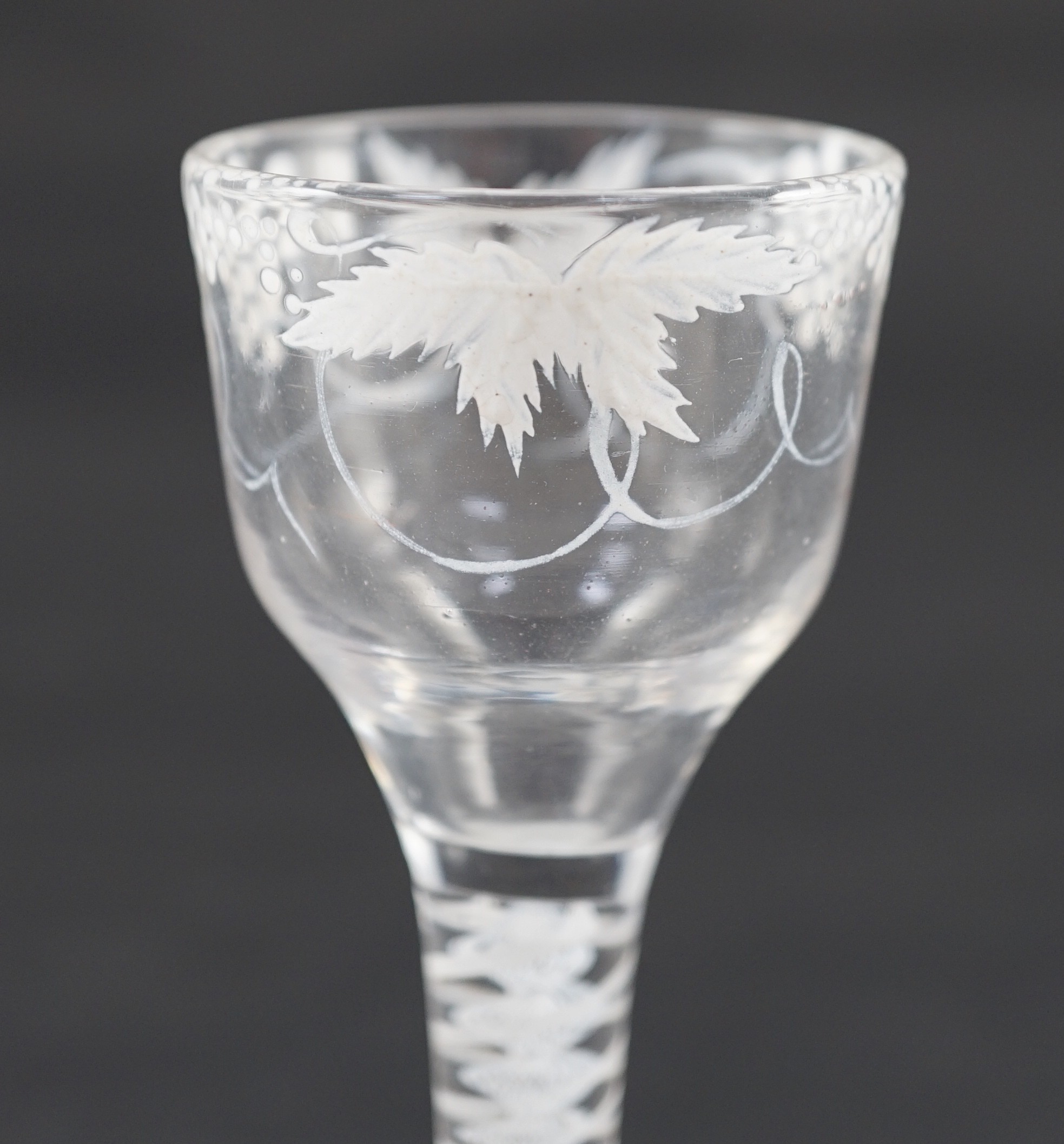 A Beilby enamelled wine glass, c.1765, 14cm high, rim reduced